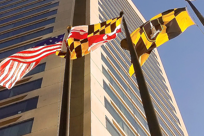 flags of US, Maryland, Baltimore with building