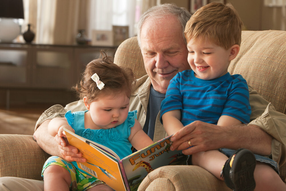 Grandpa reading to young children