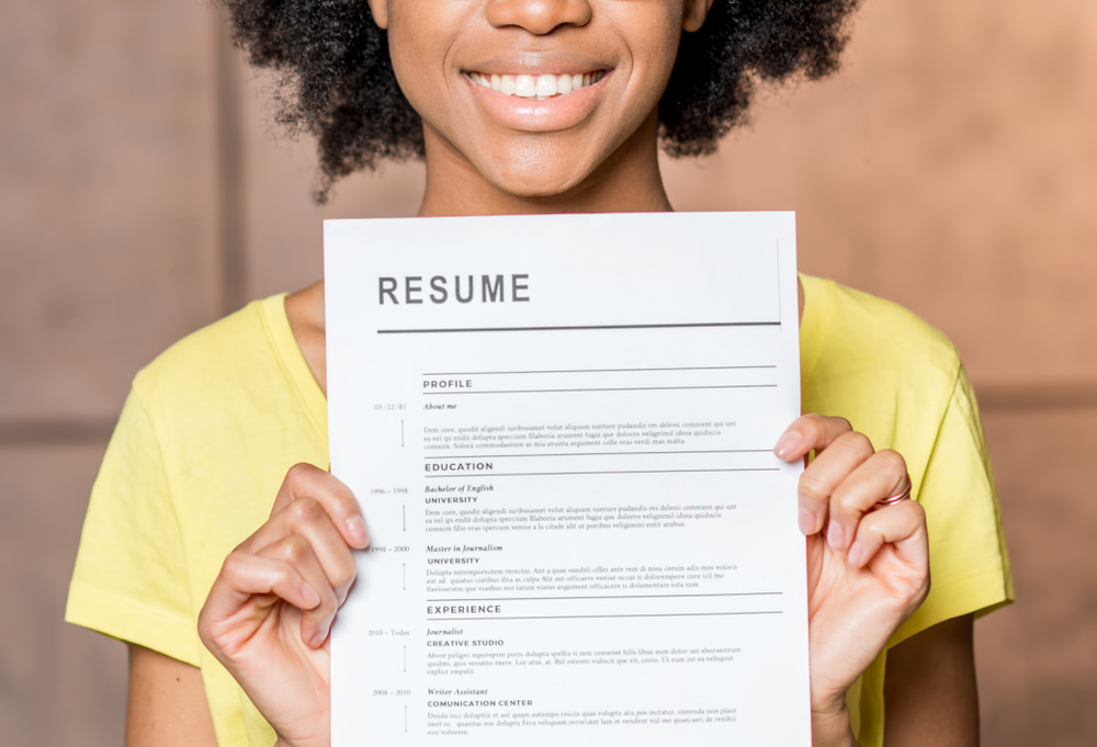 woman holding a completed resume