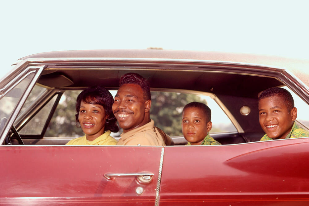 African American family snapshot  - old photo of family in a vintage car