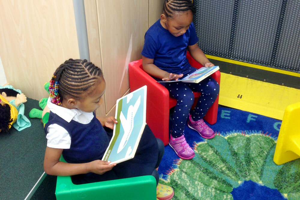 young children reading in the Pratt Book Buggy