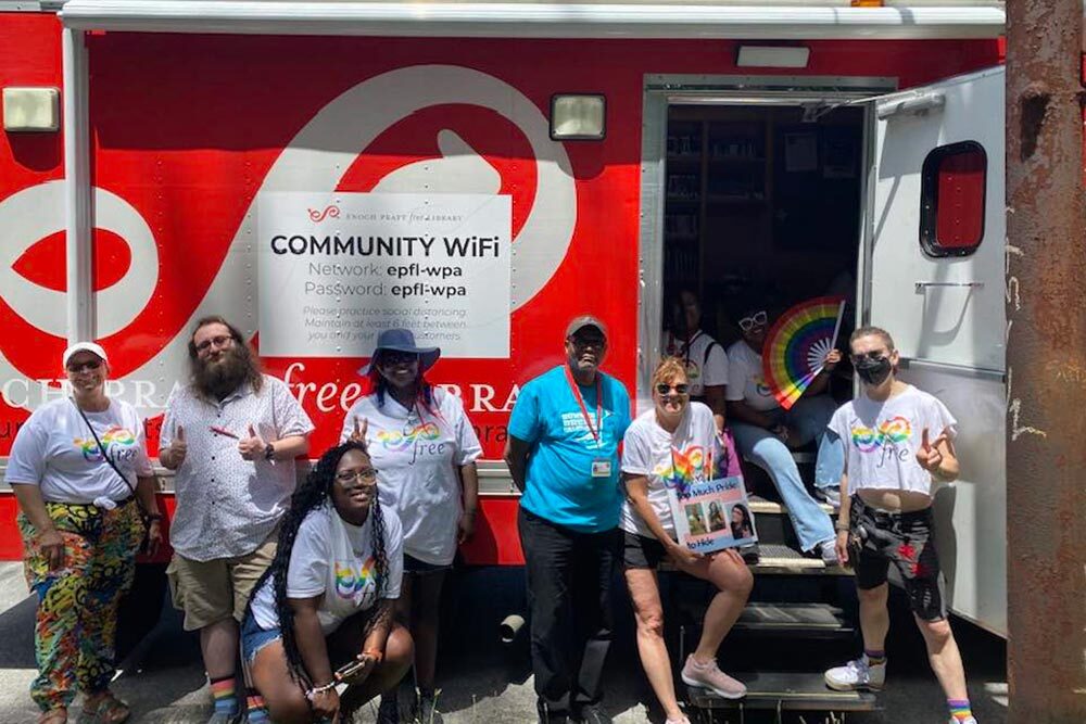 Community WiFi - Pratt Bookmobile with Staff at a Pride event and Community WiFi login.