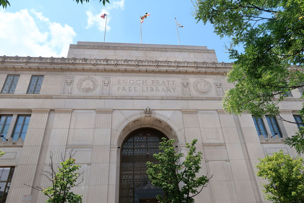 Central Library entrance with flags flying above - Enoch Pratt Free Library headquarters