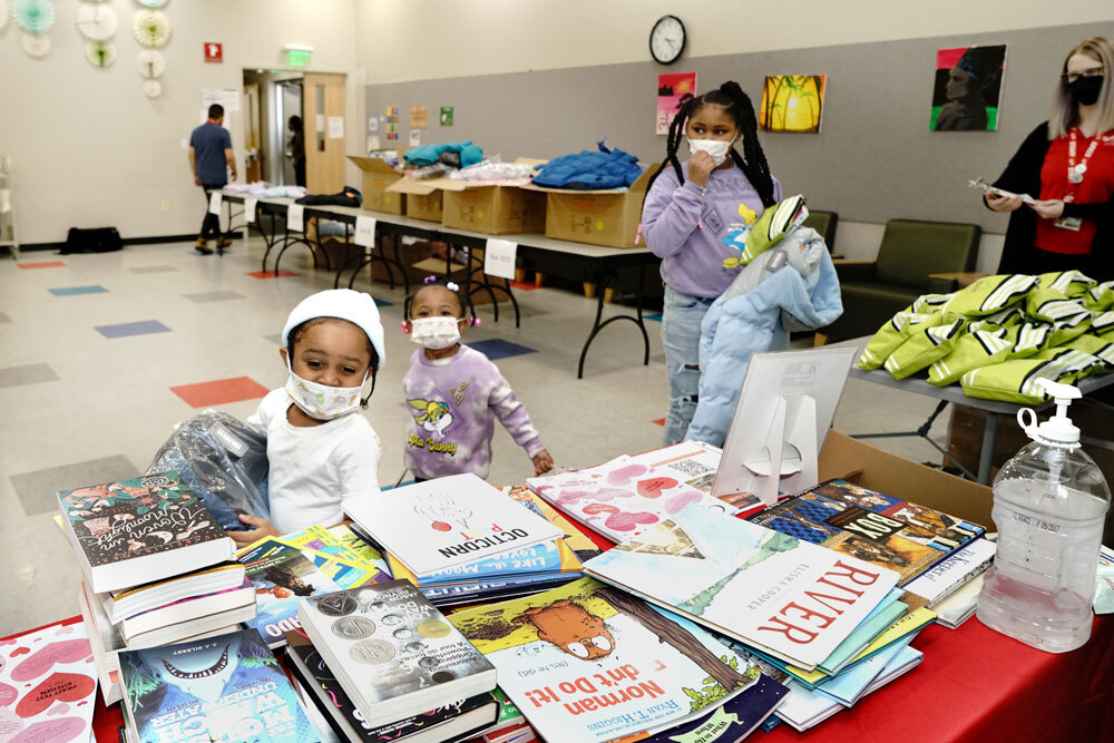 kids getting free books and coats in partnership with Operation Warm and Port Discovery