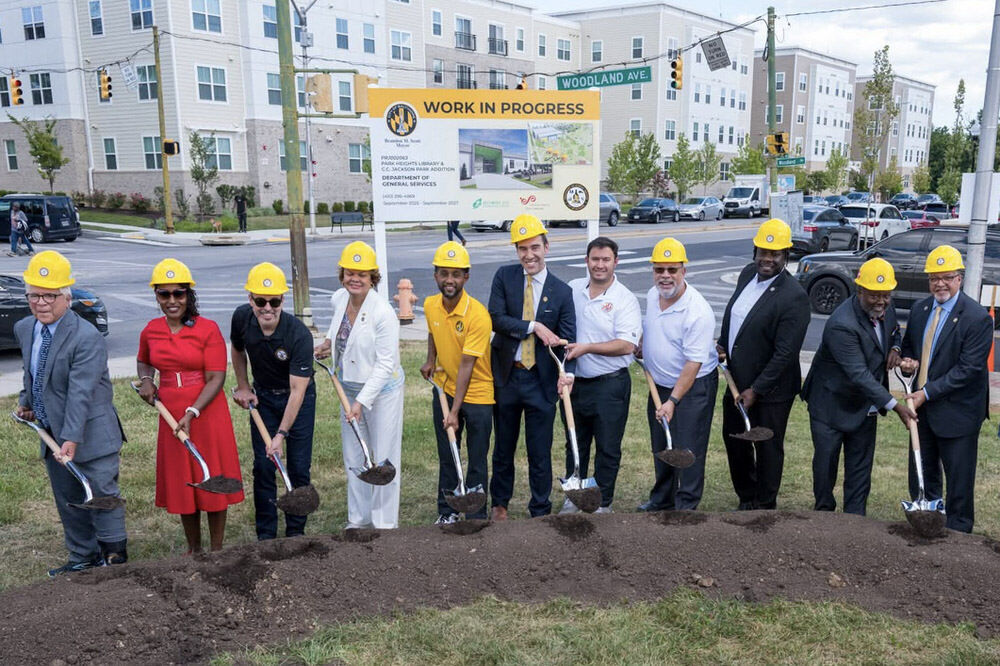Park Heights Branch groundbreaking: community officials with hard hats and shovels.