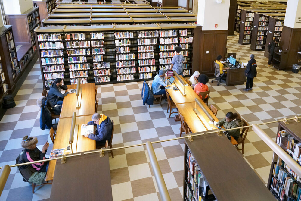 Looking down on library tables and bookshelves