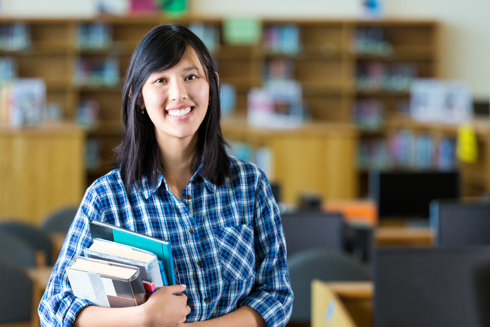 smiling teacher with books