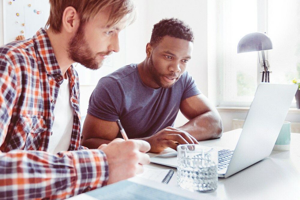 business planning - 2 men with a laptop and notebook