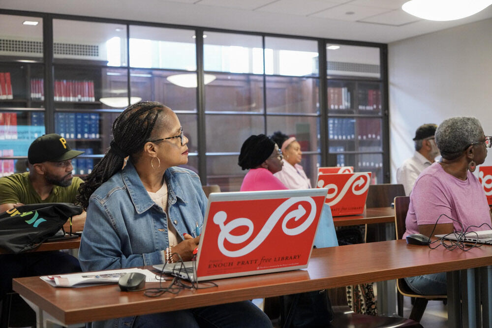 computer class at Pratt Library - people listening with Pratt laptops