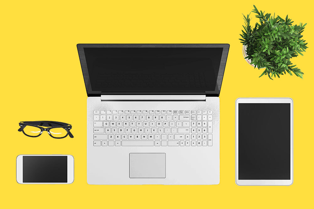 Coworking space - glasses phone tablet laptop plant on yellow