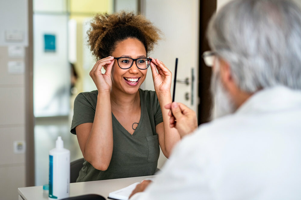 young woman getting new eyeglasses at the optometrist