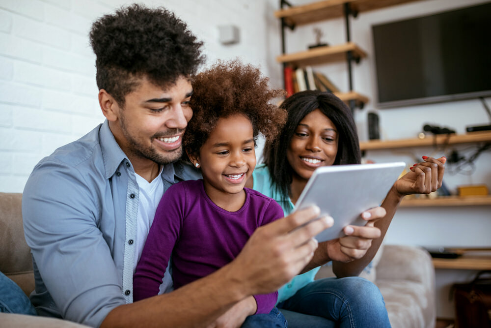 family with digital tablet at home