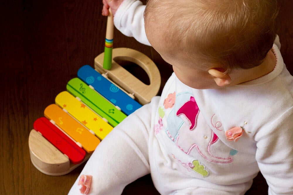 Early Learning events, showing a baby using a color-coded xylophone
