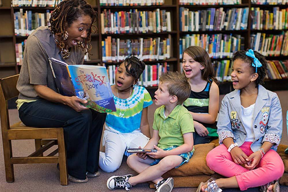 young children and a librarian at Pratt Library for storytime.