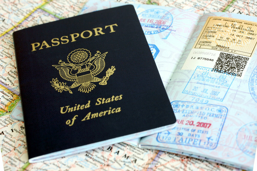 Passport with travel stamps on a map