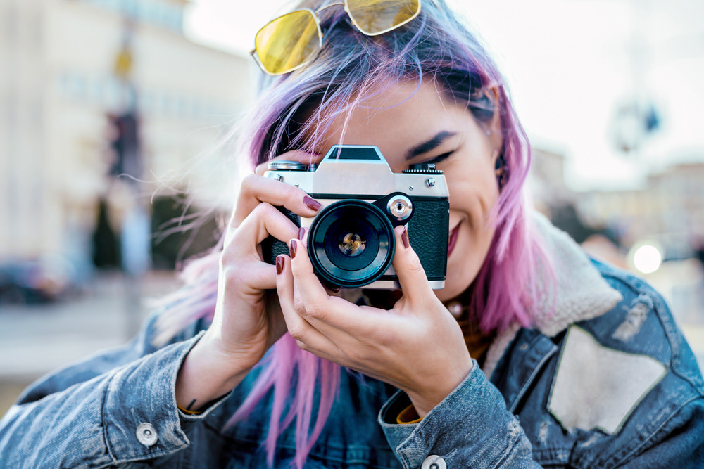 woman with a camera taking a photo