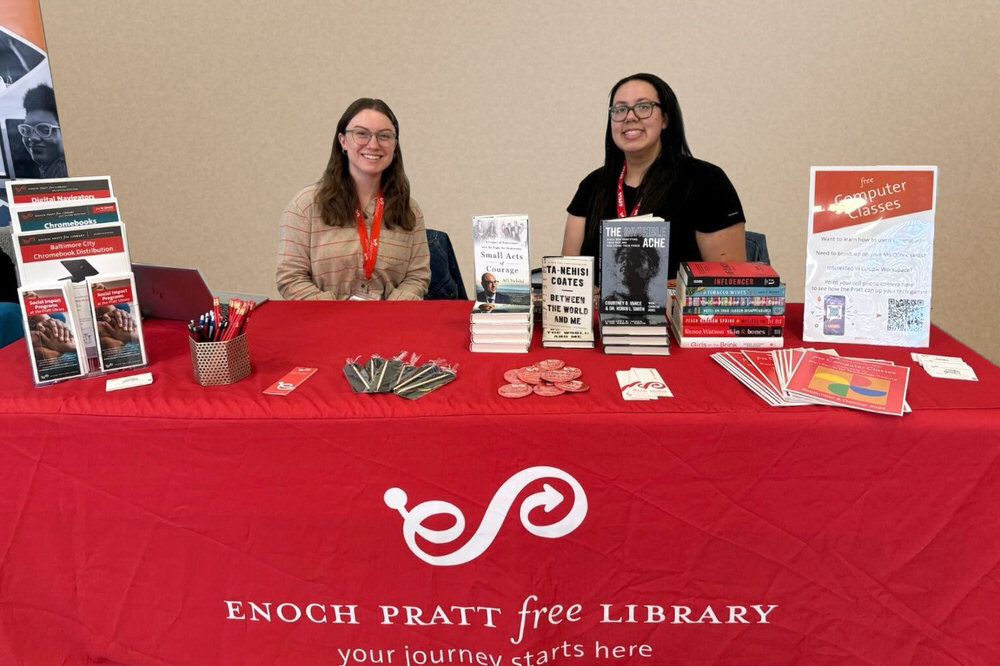 staff at a table in the community, with Pratt logo and sample services