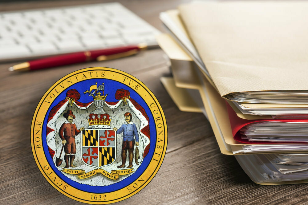 Maryland State Seal, folders, keyboard, pen on desk - Request for Information documents