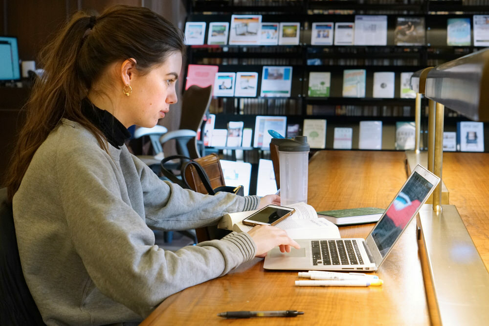 woman doing online research at a Central Library table