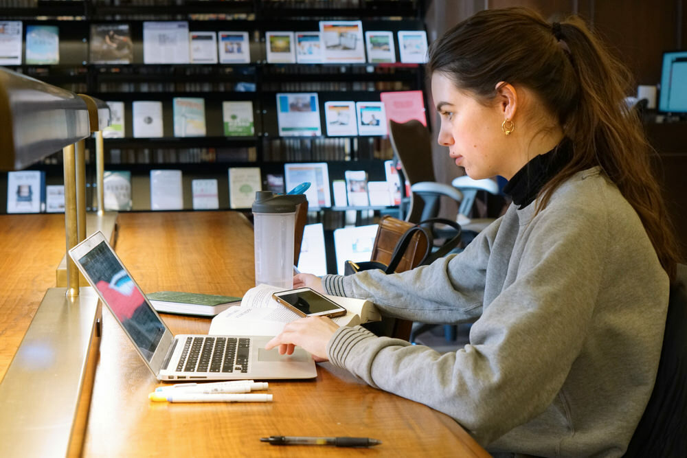 woman doing online research at a Central Library table