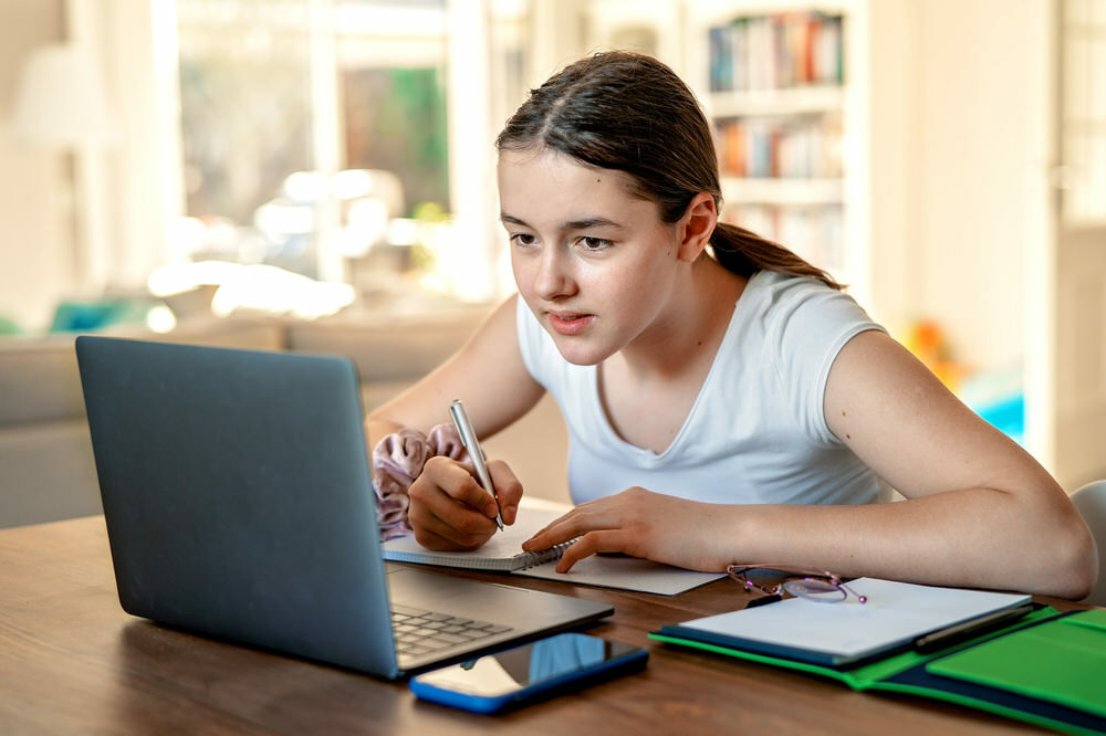 student at home learning on a laptop