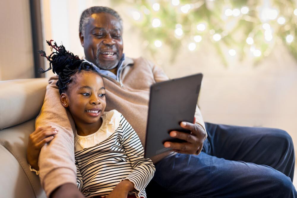family members enjoying downloaded or streaming content, cozy winter background