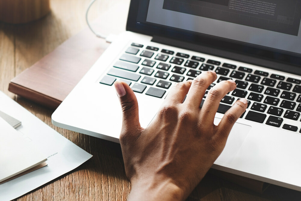 hand typing, searching the web, using a laptop