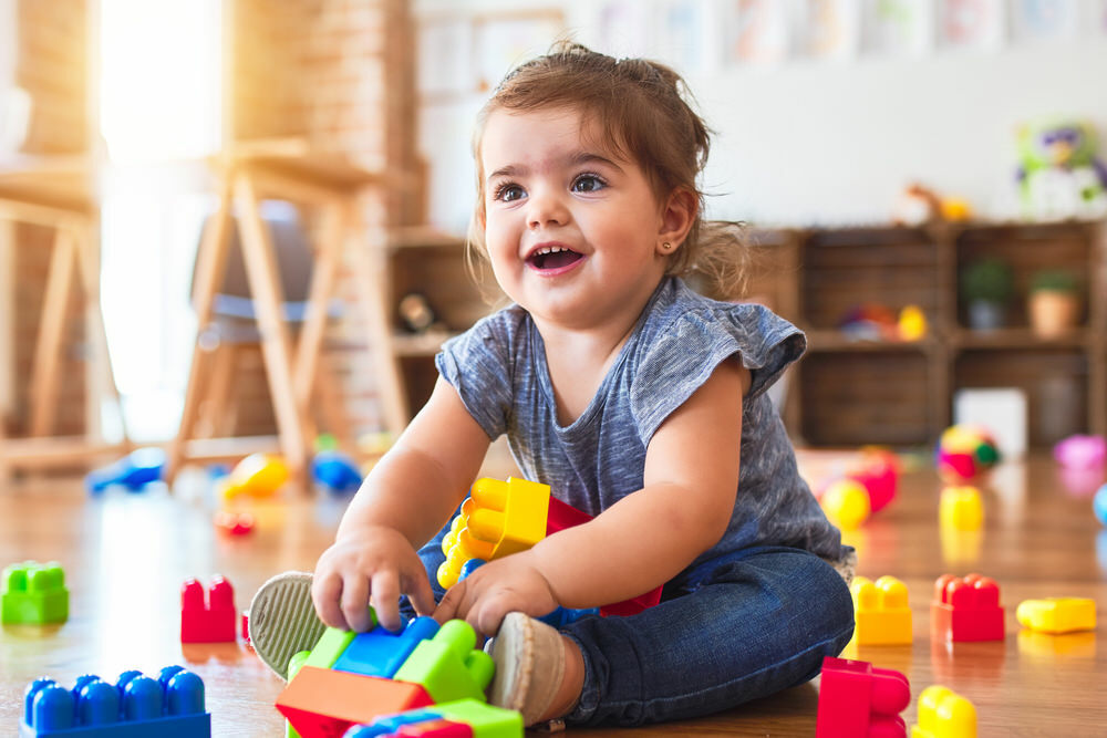 preschool child playing and smiling