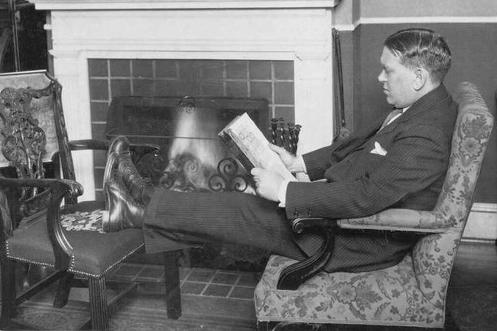H.L. Mencken reading at home on Hollins Street.