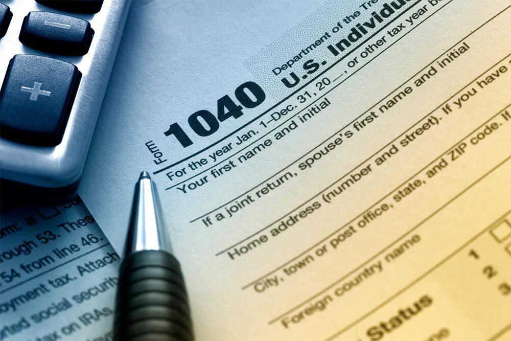 Free tax prep - 1040 form for taxes with pen and calculator
