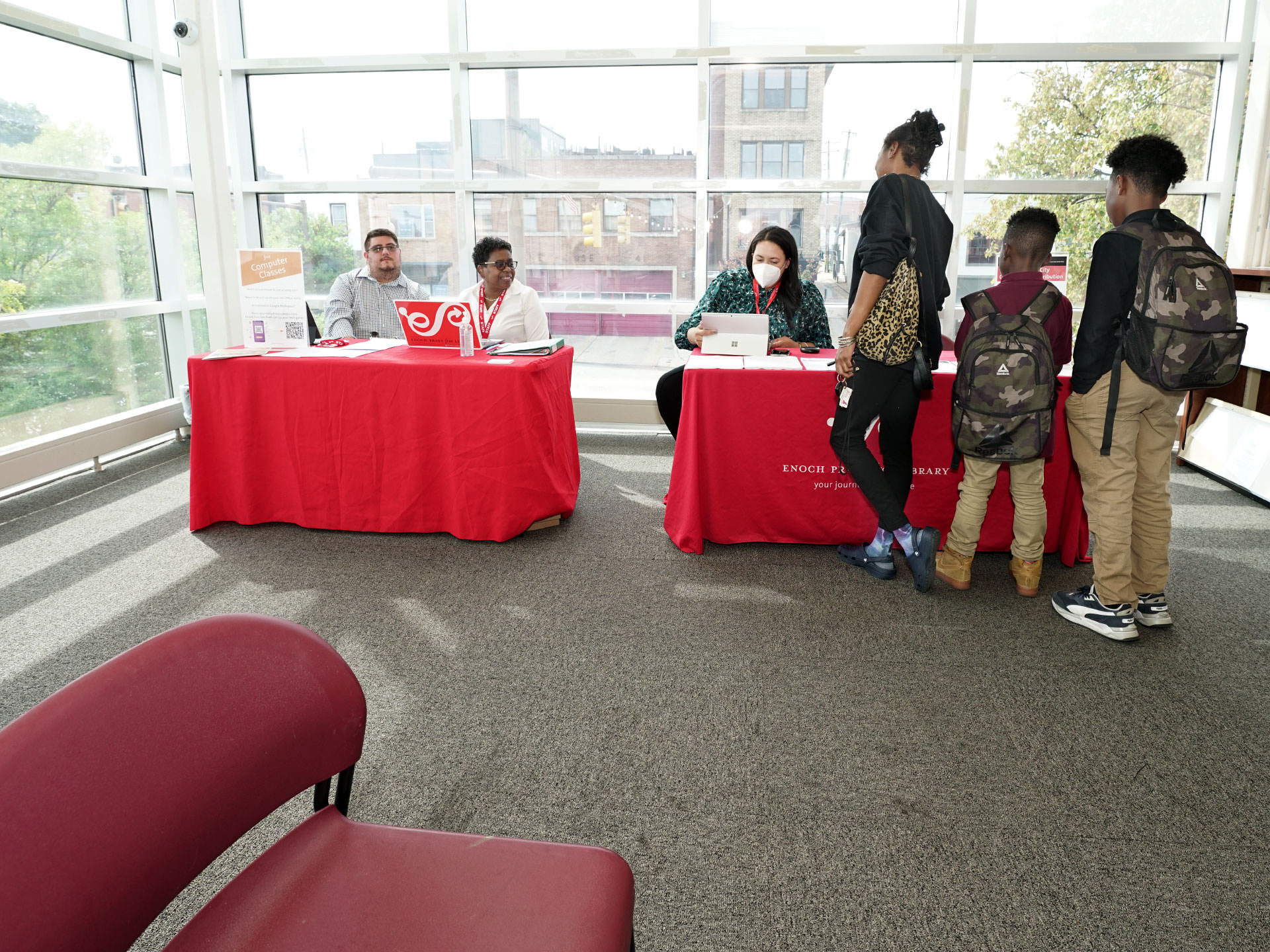 HP Chromebooks giveaway at Pratt Library - tables with staff and a family