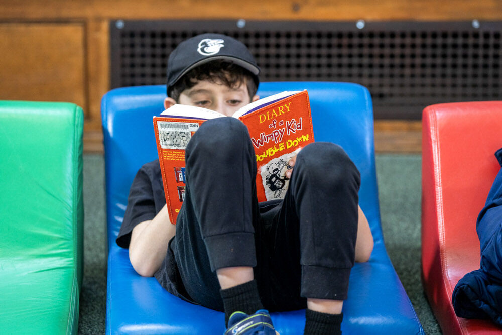 child reading a Pratt Library book.