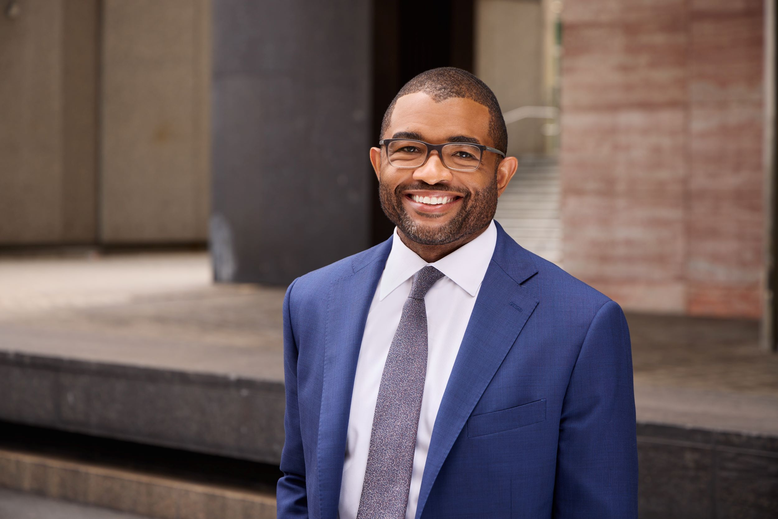 Photo og Jamar R. Brown, smiling and wearing a blue suit.