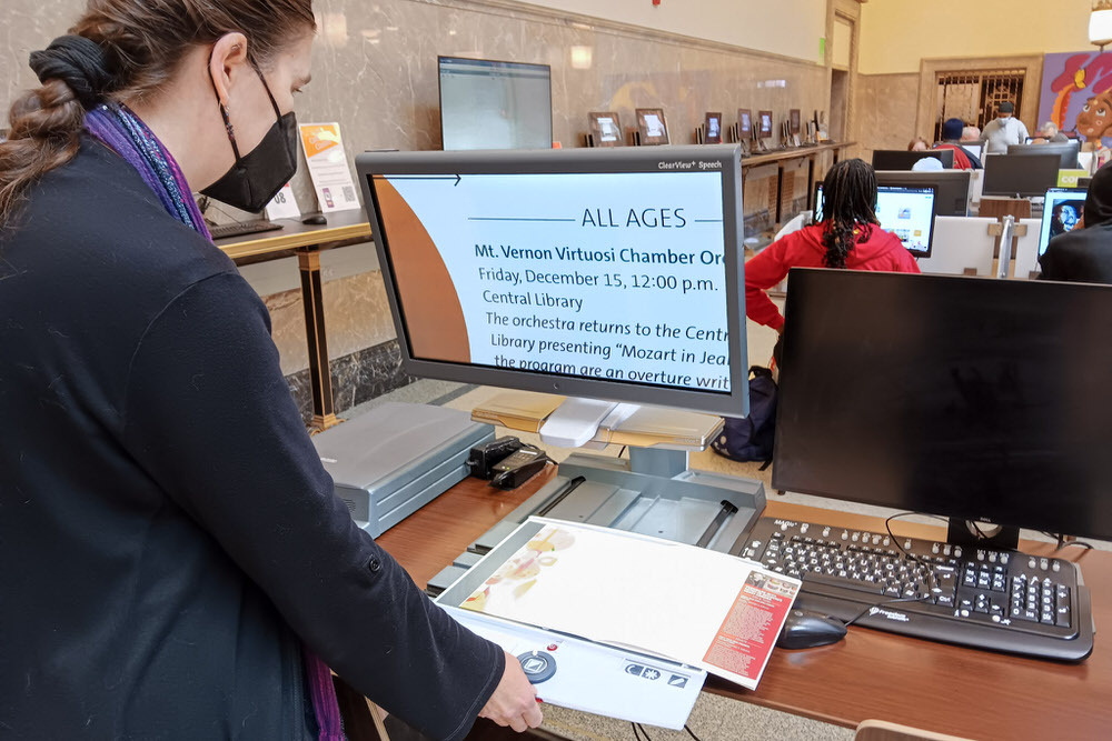 Pratt accessibility coordinator with a computer screen showing enlarged text