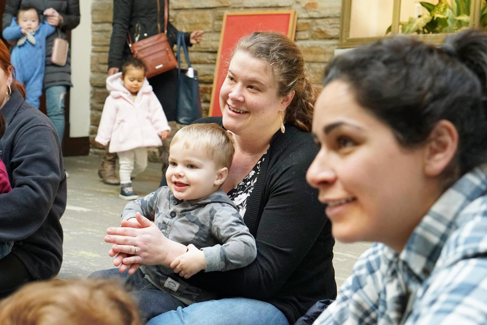 families enjoying a program for babies and parents in the Children's Department