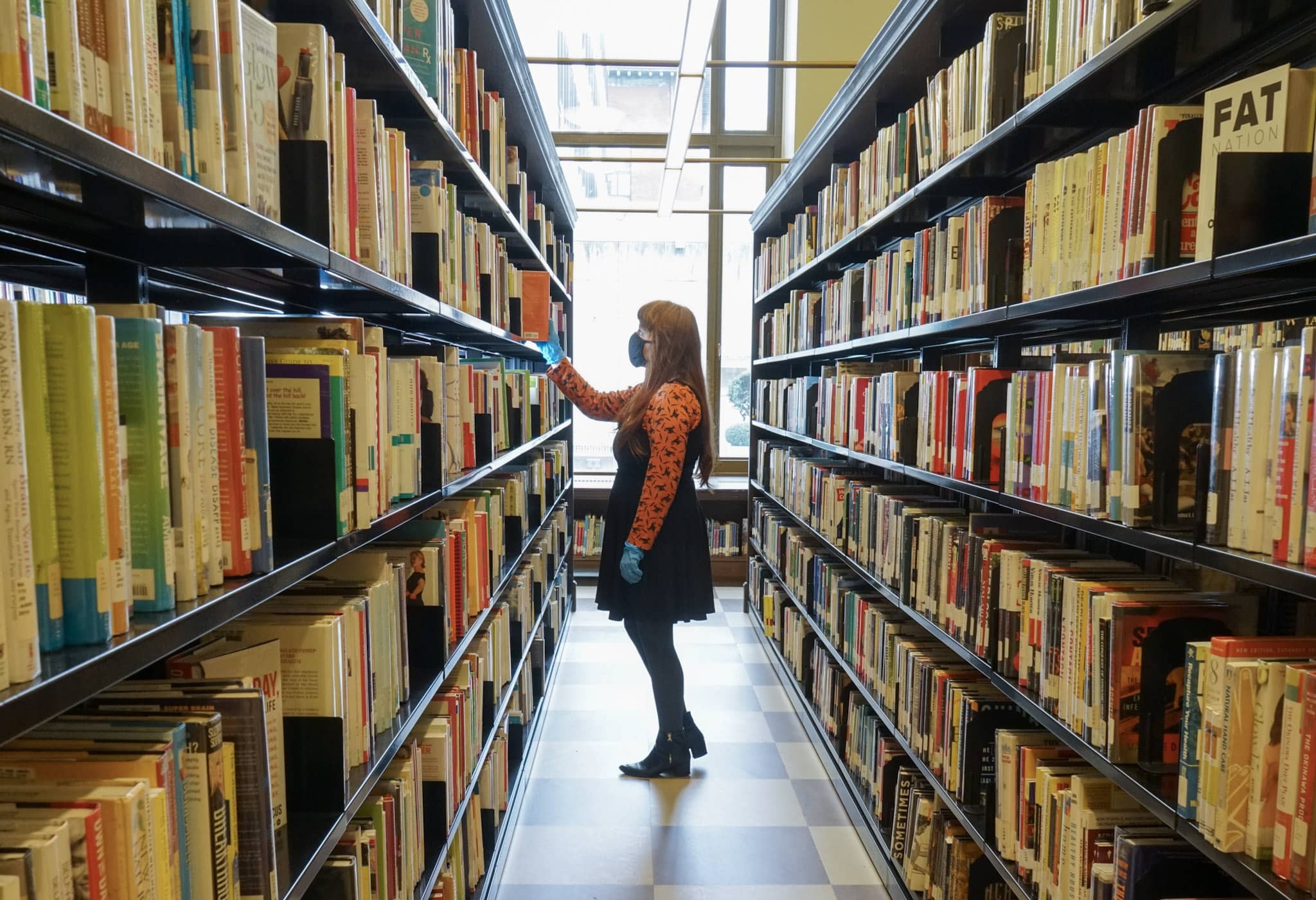 Woman with mask browsing in Central Library