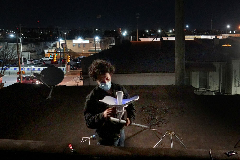 worker installing a rooftop antenna