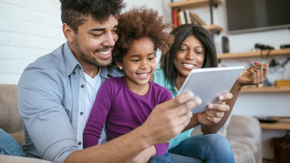 family with a digital tablet at home