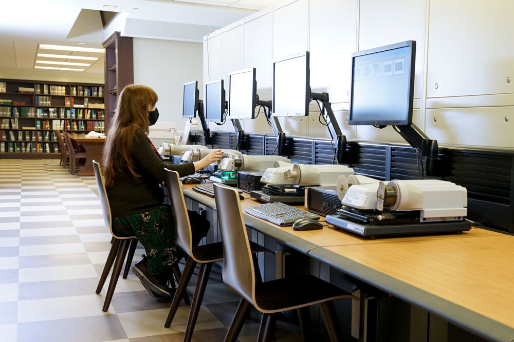 people in Periodicals, using a microfilm reader