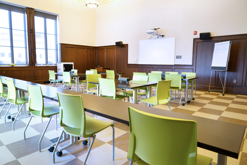 Teen Center Learning Lab room with green chairs and long tables