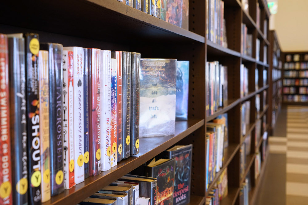 teen books on bookshelves, Y stickers for YA in the Teen Center