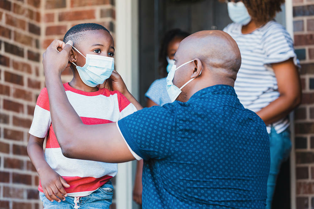 family members putting their COVID-19 face masks on before leaving home