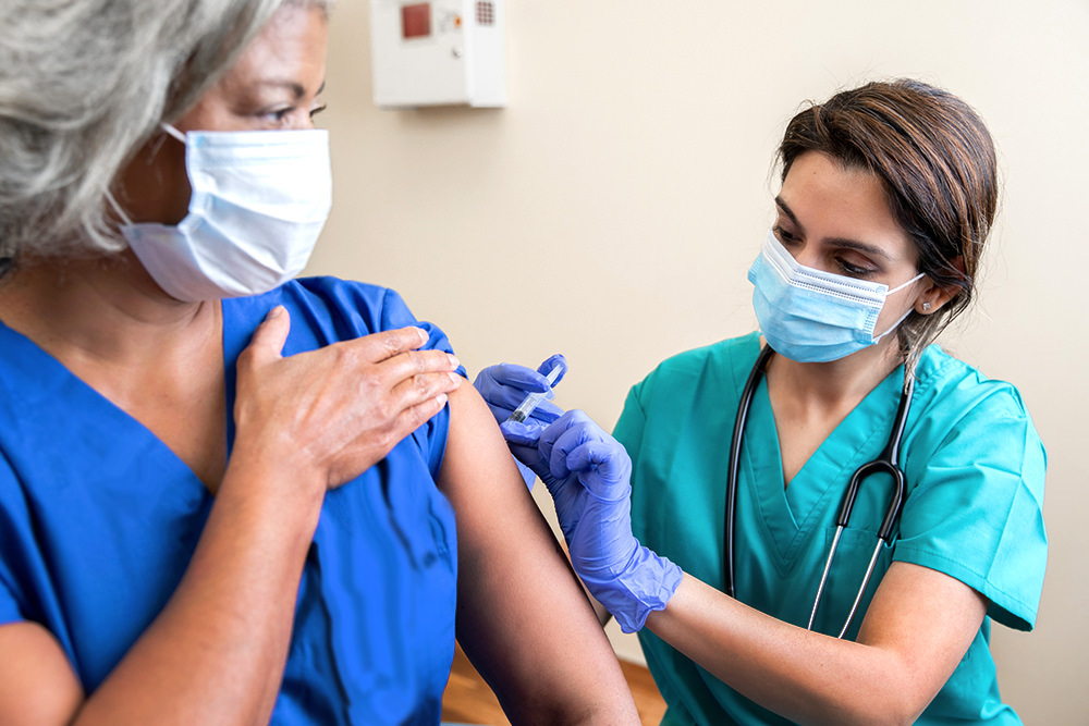 COVID-19 vaccine shot being administered by a nurse