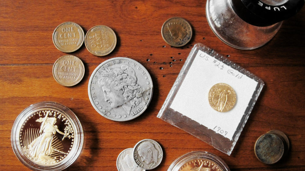 evaluating old money - American coins and a loupe