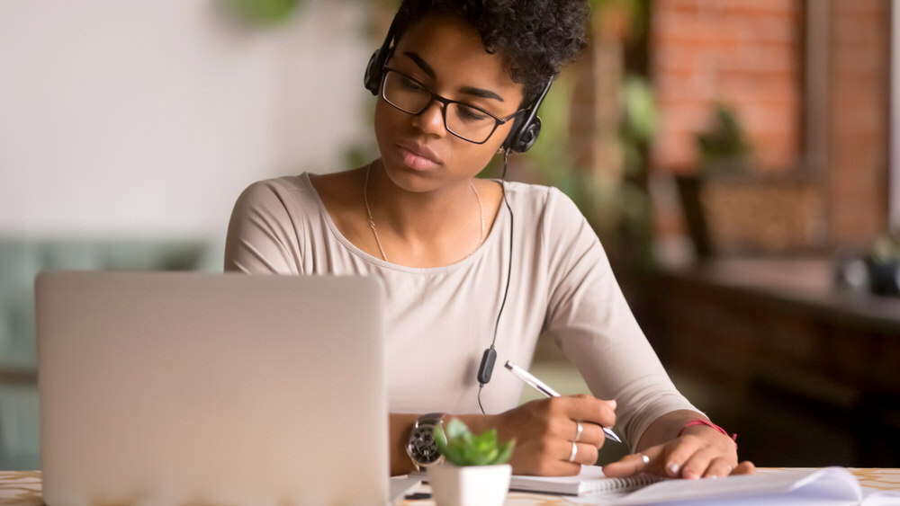 serious young woman with laptop doing research