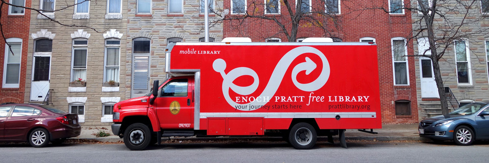 Pratt Library Bookmobile on a Baltimore city street with rowhouses