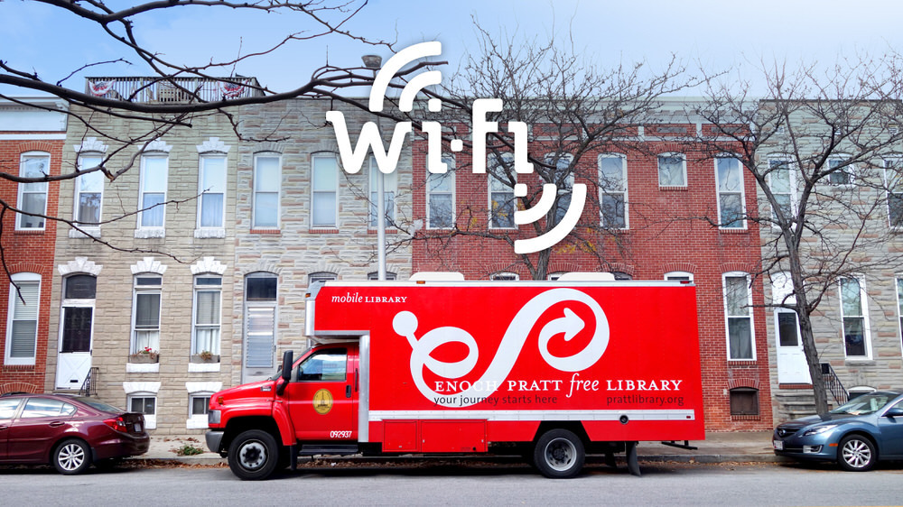 Community Wi-Fi - Bookmobile on a Baltimore street with a hotspot logo