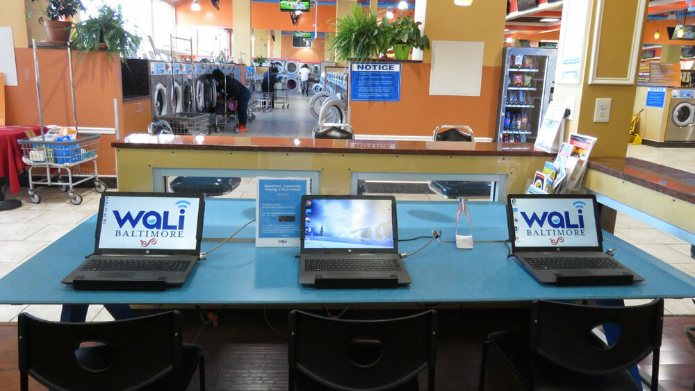 WaLi laptops at a Baltimore laundromat - photo credit Jessica Smith on Medium