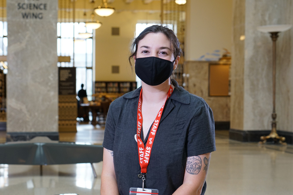 Pratt Library social worker smiling with mask and staff ID lanyard
