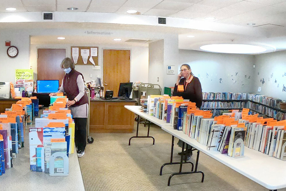 staff preparing books on hold and answering phones at the Roland Park branch